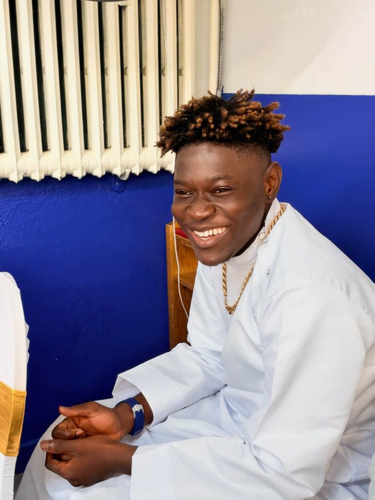Smiling young member in white garment