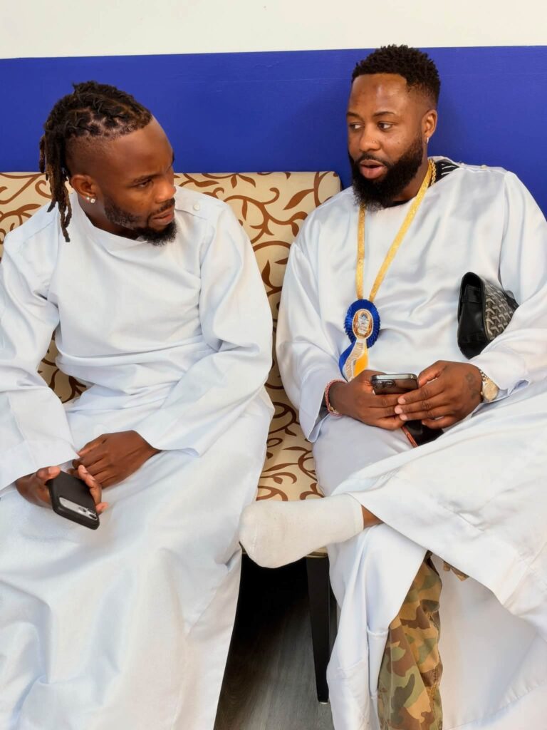 Two members in white garments in conversation