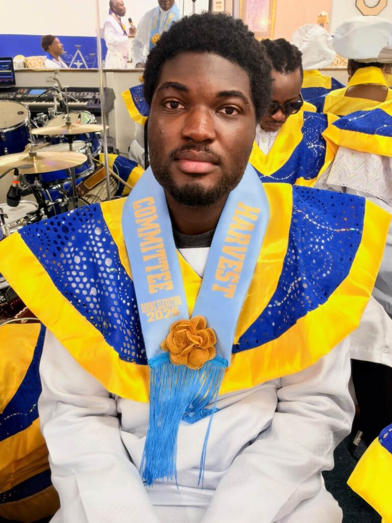 Harvest Committee member in blue and gold collar and light blue sash