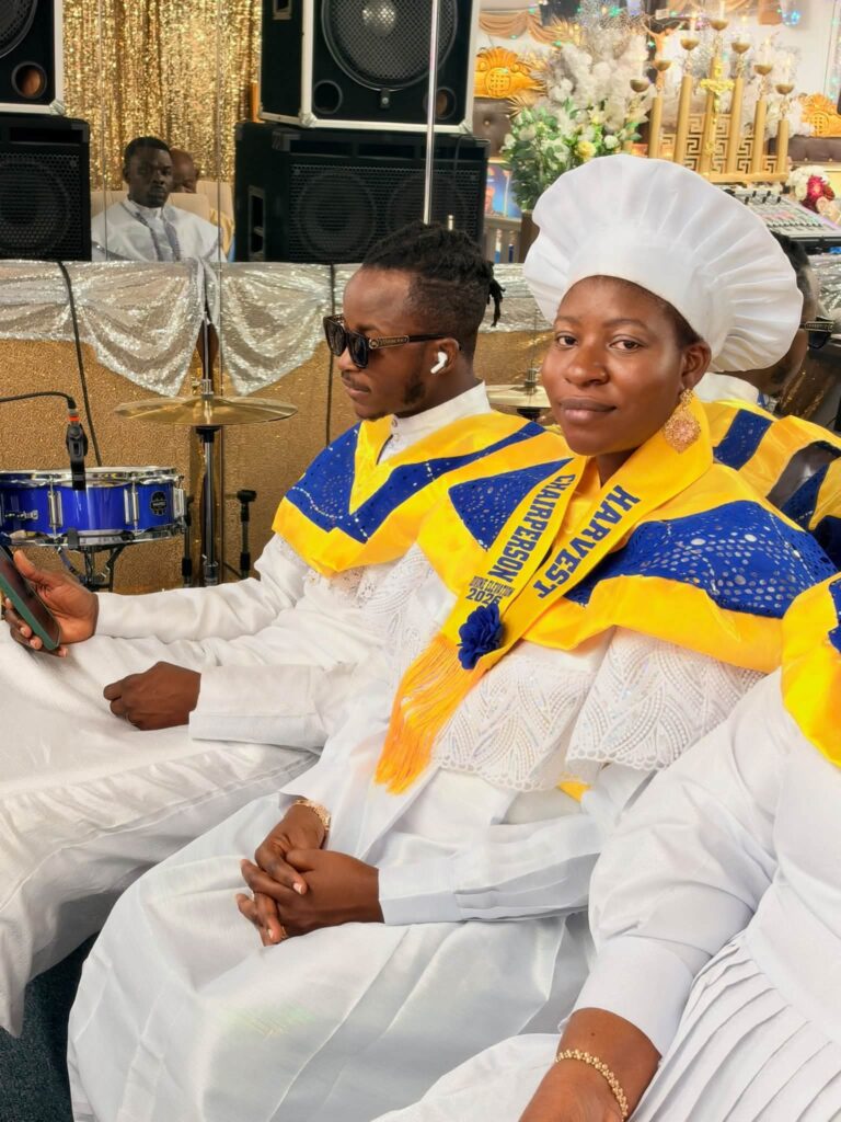 Harvest Chairperson seated with celebrants in blue and gold harvest collars